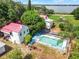 Overhead shot of the property featuring a large house, a beautiful pool, and expansive greenery at 9023 Silver Lake Dr, Leesburg, FL 34788