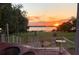 Picturesque sunset view from the back porch overlooking the lake, enhancing this tranquil home's setting at 9023 Silver Lake Dr, Leesburg, FL 34788
