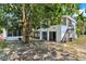 A backyard view of the house, showcasing the staircase and glass windows at 9023 Silver Lake Dr, Leesburg, FL 34788