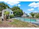 View of the pool and part of the backyard with a black metal fence separating the grass at 9023 Silver Lake Dr, Leesburg, FL 34788