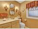 Bathroom with decorative lighting, gold fixtures and decorative wallpaper at 9023 Silver Lake Dr, Leesburg, FL 34788