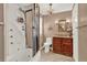 Bathroom featuring a shower stall, wood cabinets, and granite countertops at 9023 Silver Lake Dr, Leesburg, FL 34788