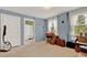 Spare bedroom with blue walls, carpet floors, and natural light at 9023 Silver Lake Dr, Leesburg, FL 34788