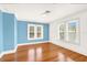 Bright bedroom featuring hardwood floors, white trim, and multiple windows for ample natural light at 9023 Silver Lake Dr, Leesburg, FL 34788