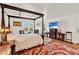Spacious bedroom featuring a four-poster bed, seating area, and decorative accents at 9023 Silver Lake Dr, Leesburg, FL 34788