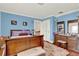 Cozy bedroom with blue walls, wood floors, and vintage-style furniture at 9023 Silver Lake Dr, Leesburg, FL 34788