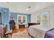 Bedroom featuring two bright windows, hardwood floors, and traditional furnishings at 9023 Silver Lake Dr, Leesburg, FL 34788