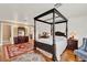 Bedroom featuring a four-poster bed, hardwood floors, and traditional decor at 9023 Silver Lake Dr, Leesburg, FL 34788