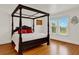 Spacious bedroom with hardwood floors and a large window that provides natural lighting at 9023 Silver Lake Dr, Leesburg, FL 34788
