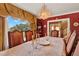 Ornate dining room featuring a large window with a view of lush greenery at 9023 Silver Lake Dr, Leesburg, FL 34788