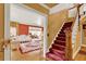 Welcoming foyer with ornate staircase, hardwood floors and a glimpse into the living room at 9023 Silver Lake Dr, Leesburg, FL 34788