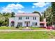 Charming two-story home with a red-tiled roof, well-manicured lawn, and landscaped front yard at 9023 Silver Lake Dr, Leesburg, FL 34788