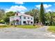 Charming two-story home with red-tiled roof and well-manicured lawn with mature landscaping at 9023 Silver Lake Dr, Leesburg, FL 34788