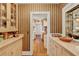 Charming hallway featuring vintage wallpaper and built-in cabinets at 9023 Silver Lake Dr, Leesburg, FL 34788