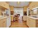 Spacious kitchen with light wood cabinets, hardwood floors, and open access to the living room at 9023 Silver Lake Dr, Leesburg, FL 34788