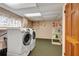Functional laundry room with modern appliances and storage shelves at 9023 Silver Lake Dr, Leesburg, FL 34788