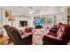 Cozy living room featuring white fireplace and plush seating at 9023 Silver Lake Dr, Leesburg, FL 34788