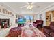 Bright living room featuring a decorative white fireplace, plush seating, and a view to an outdoor deck at 9023 Silver Lake Dr, Leesburg, FL 34788