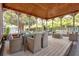 Stylish outdoor living space with a glass dining table and comfortable seating, perfect for entertaining guests at 9023 Silver Lake Dr, Leesburg, FL 34788