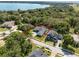 Aerial view of the property, showcasing landscaping, neighborhood, lake views at 9518 Mid Summer Ln, Leesburg, FL 34788