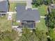 An aerial view of the landscaped property, pool, fire pit, and boat parking at 9518 Mid Summer Ln, Leesburg, FL 34788