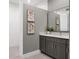 Bright bathroom featuring a large mirror, modern vanity, and clean lines at 9518 Mid Summer Ln, Leesburg, FL 34788