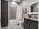Bathroom featuring grey tiled walls, a shower with a curtain, and a granite vanity at 9518 Mid Summer Ln, Leesburg, FL 34788