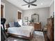 Comfortable bedroom featuring a ceiling fan, wood furnishings, and stylish decor with a serene atmosphere at 9518 Mid Summer Ln, Leesburg, FL 34788