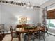 Formal dining room featuring a chandelier and decor, perfect for hosting dinner parties and holiday gatherings at 9518 Mid Summer Ln, Leesburg, FL 34788
