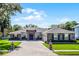 Stunning single-story home featuring stacked stone accents and a spacious brick driveway at 9518 Mid Summer Ln, Leesburg, FL 34788