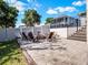 Backyard with pavers, fire pit and chairs, and stairs to the pool area at 9518 Mid Summer Ln, Leesburg, FL 34788