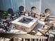 Close up view of fire pit area with stone pavers and seating at 9518 Mid Summer Ln, Leesburg, FL 34788