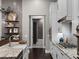 A gourmet kitchen with white cabinetry, granite countertops, and stainless steel appliances is ready for culinary creativity at 9518 Mid Summer Ln, Leesburg, FL 34788