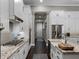 Contemporary kitchen with granite countertops, stainless steel appliances and ample cabinet space at 9518 Mid Summer Ln, Leesburg, FL 34788