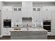 Bright and airy kitchen featuring custom cabinetry, granite countertops, and stainless steel appliances at 9518 Mid Summer Ln, Leesburg, FL 34788