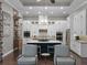 Beautiful kitchen featuring a center island, custom cabinetry, and modern lighting fixtures at 9518 Mid Summer Ln, Leesburg, FL 34788