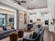 Open-concept living room showcasing hardwood floors, stylish furniture, and access to the kitchen at 9518 Mid Summer Ln, Leesburg, FL 34788
