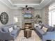 Inviting living room featuring a stone fireplace, hardwood floors, and a ceiling fan at 9518 Mid Summer Ln, Leesburg, FL 34788