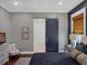 Stylish bedroom featuring a sliding door entry to the en-suite bathroom at 9518 Mid Summer Ln, Leesburg, FL 34788