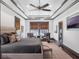 A bright main bedroom retreat with a tray ceiling, plush bed, and windows at 9518 Mid Summer Ln, Leesburg, FL 34788
