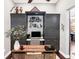 Cozy home office with custom built-in cabinetry and a wooden desk, perfect for remote work or study at 9518 Mid Summer Ln, Leesburg, FL 34788