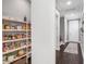 Walk-in pantry with generous shelving space provides ample storage for all your culinary essentials at 9518 Mid Summer Ln, Leesburg, FL 34788