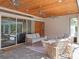 Relaxing outdoor patio with ceiling fans, wicker seating, and stylish furniture arrangement at 9518 Mid Summer Ln, Leesburg, FL 34788