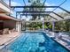 Stunning screened pool with spa, and an outdoor seating area, creating the ultimate backyard oasis for relaxation at 9518 Mid Summer Ln, Leesburg, FL 34788