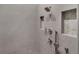 Walk-in shower featuring gray tiling and recessed shelf at 9518 Mid Summer Ln, Leesburg, FL 34788