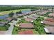 Aerial view of a neighborhood with a lake, and golf course in the distance at 453 Treviso Dr, Poinciana, FL 34759