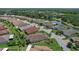 Aerial view of a home in a residential community with a lake and golf course nearby at 453 Treviso Dr, Poinciana, FL 34759