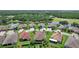 Stunning aerial view of homes by a lake, showcasing meticulous landscaping and serene surroundings at 453 Treviso Dr, Poinciana, FL 34759