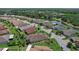 Aerial view of a home in a residential community with a lake and golf course nearby at 453 Treviso Dr, Poinciana, FL 34759
