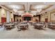 Spacious ballroom with tables, chairs, and a stage, perfect for hosting events and celebrations at 453 Treviso Dr, Poinciana, FL 34759
